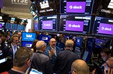 Traders congregate on the NYSE floor during the Slack direct listing