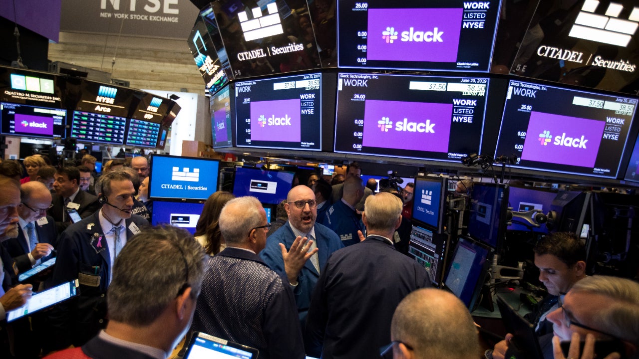 Traders congregate on the NYSE floor during the Slack direct listing