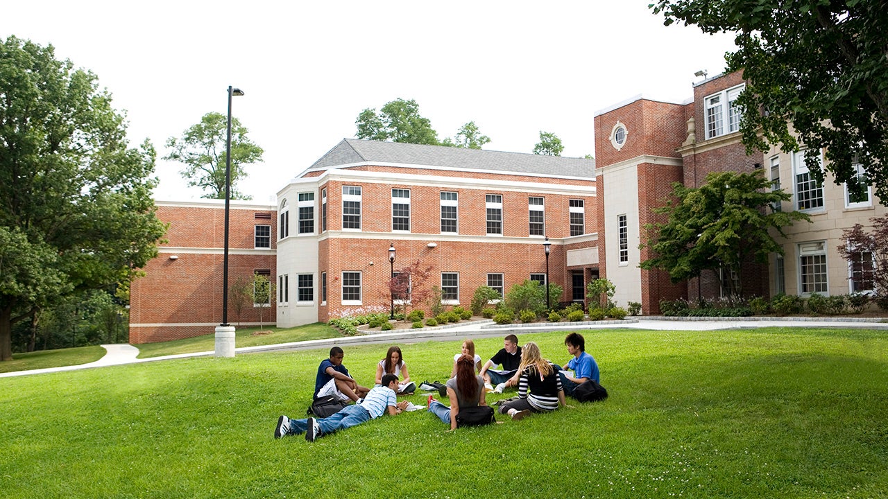 students in a college campus sitting down chatting