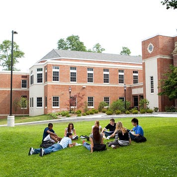 students in a college campus sitting down chatting