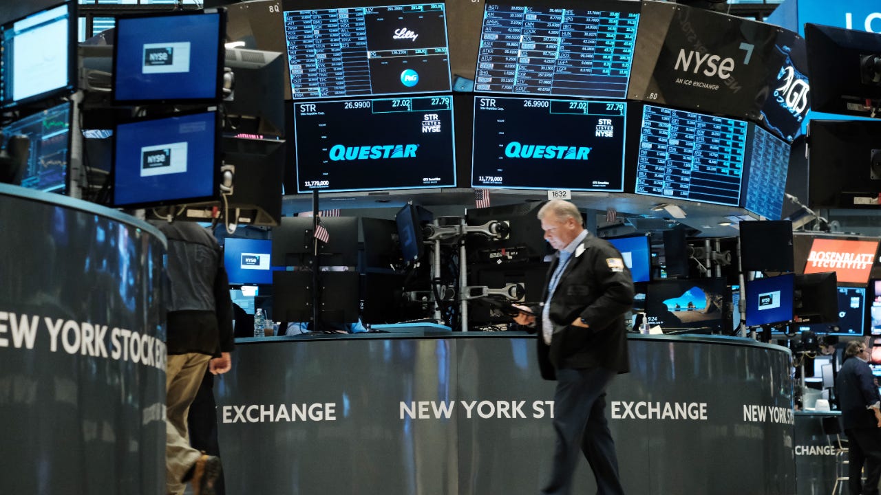 A trader walks the floor of the New York Stock Exchange