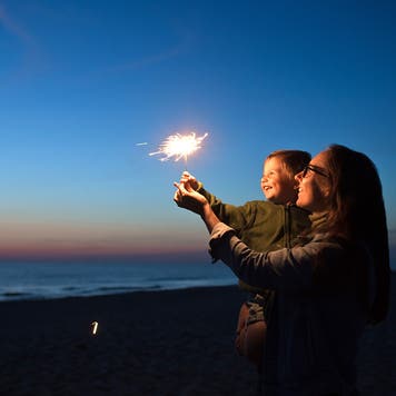 a family with sparklers on the fourth of july
