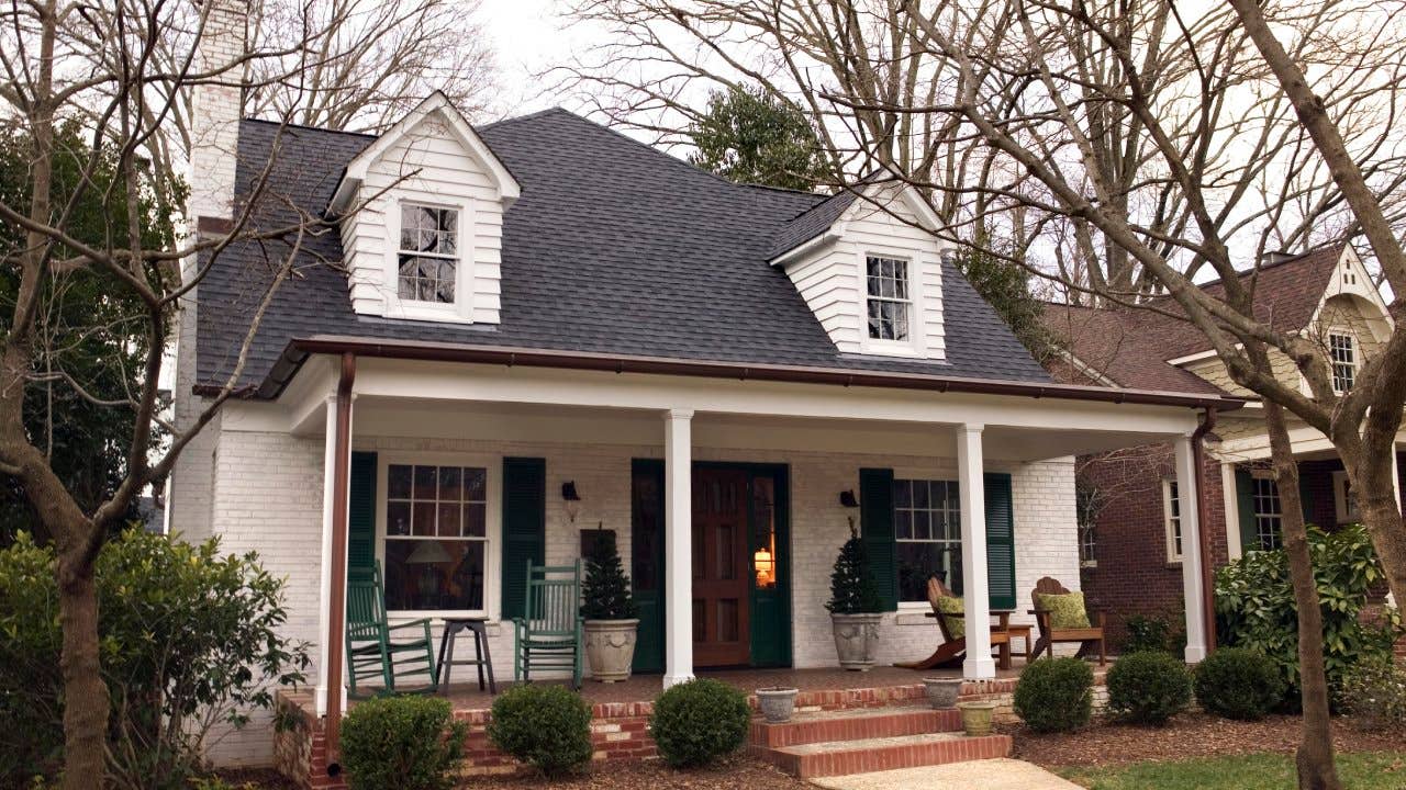 A house with rocking chairs on the porch