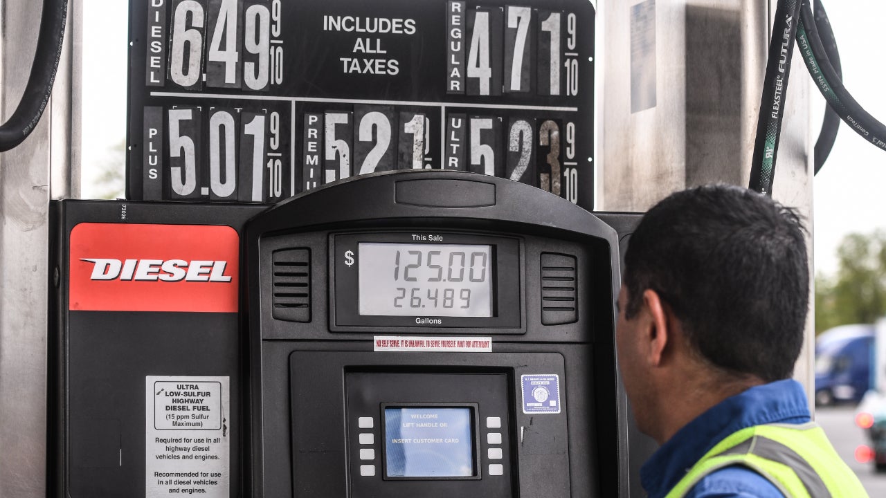 A man fills up his gas tank at high gas prices
