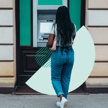Woman walking up to an ATM