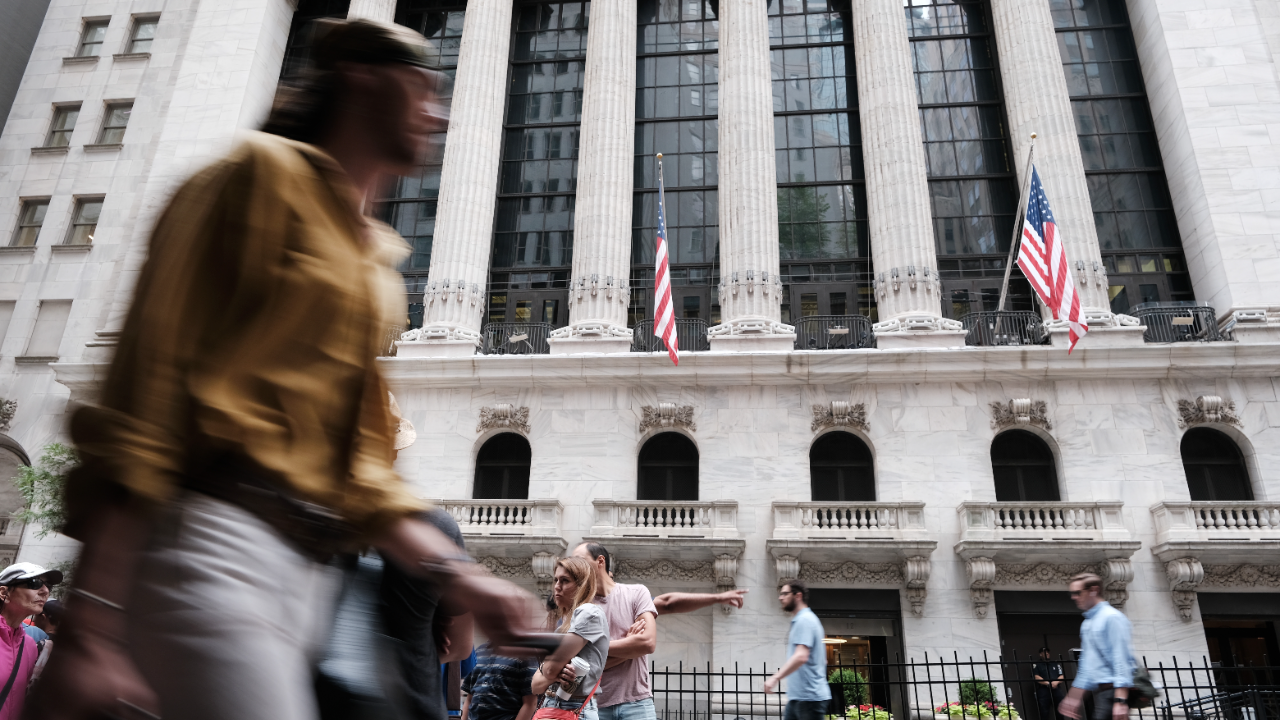 People walk by the New York Stock Exchange