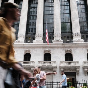 People walk by the New York Stock Exchange
