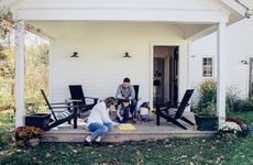 A family colors outside on their front porch