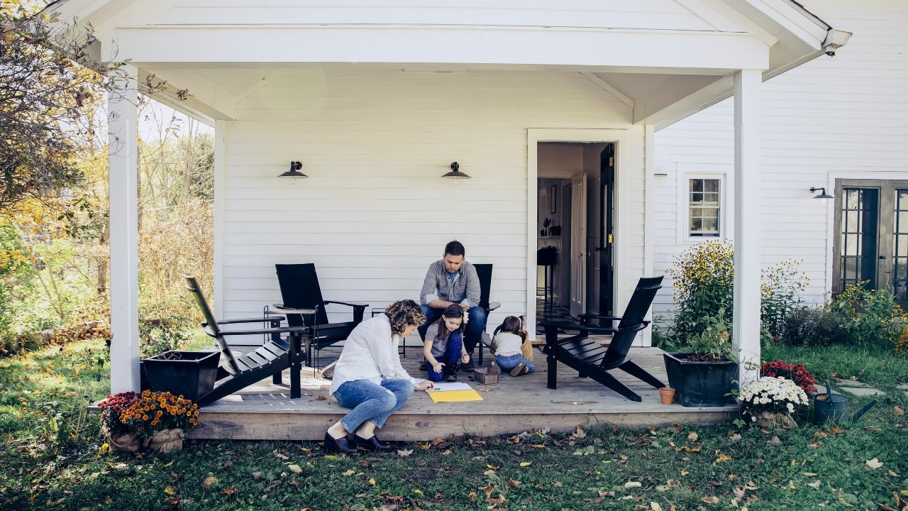 A family colors outside on their front porch