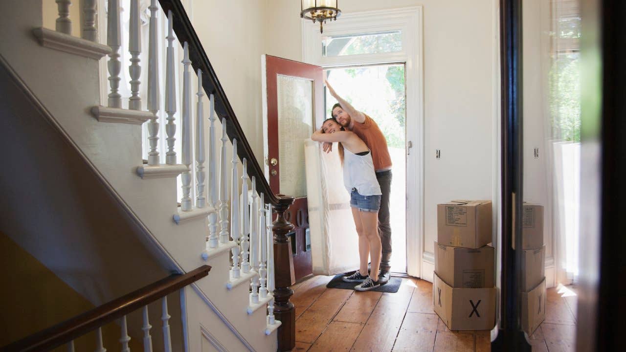 Couple standing at the entrance inside of an older home