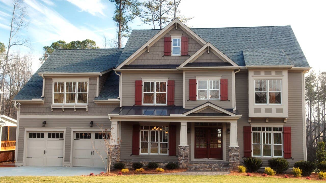 A gray accented suburban home with a double garage