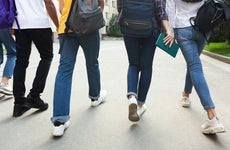 Unrecognizable teenage students in high school campus