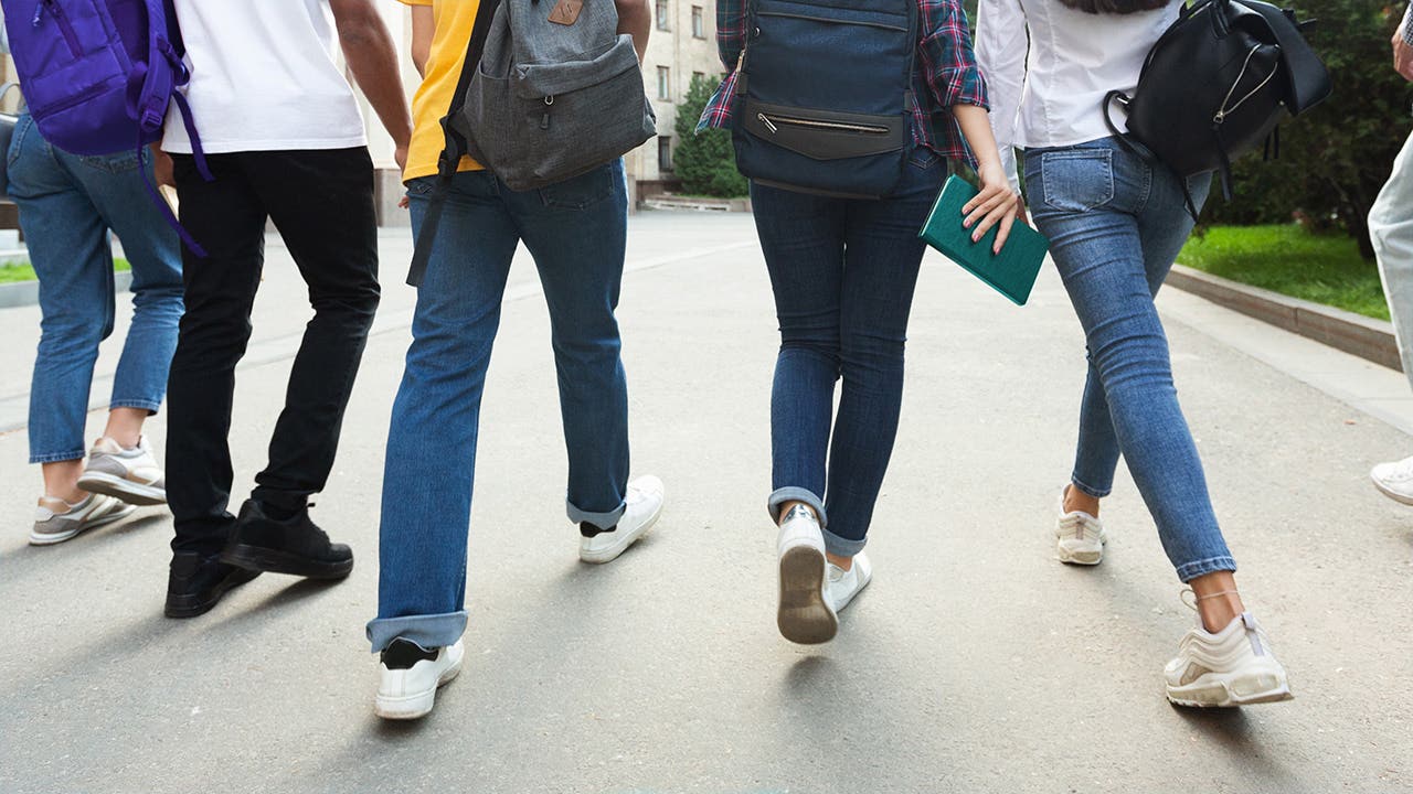 Unrecognizable teenage students in high school campus