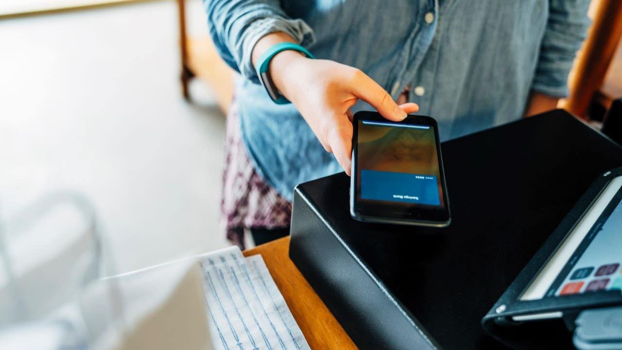 Woman making a mobile purchase at a store