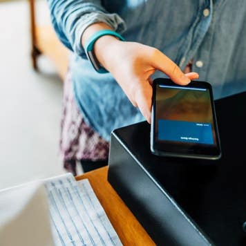 Woman making a mobile purchase at a store
