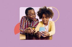 Mother and daughter looking at savings account info on a cellphone