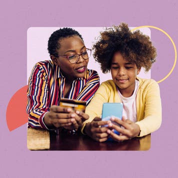 Mother and daughter looking at savings account info on a cellphone