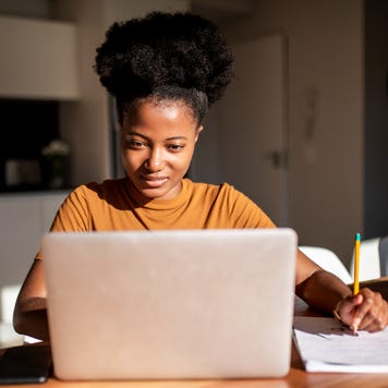 A woman researches on her laptop computer