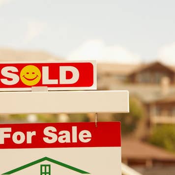 A for sale sign with a smile