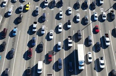 Top down view of several lanes of traffic and cars and trucks filling them.