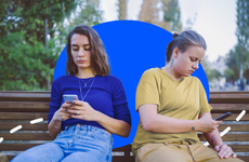 Illustration of young social media users on phones on a park bench