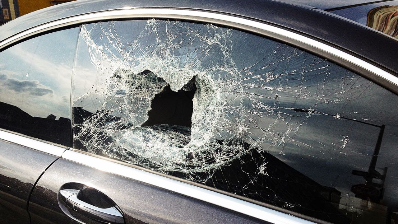 Shot of a passenger-side window that has been smashed in.