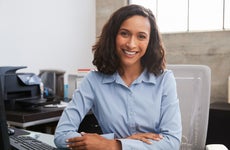 A smiling woman at an office desk