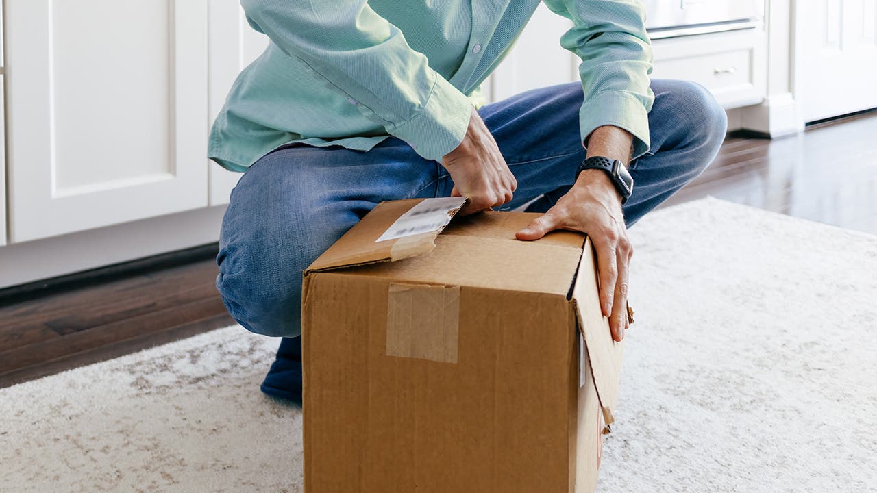 Man Opens Package After Delivery of Online Order