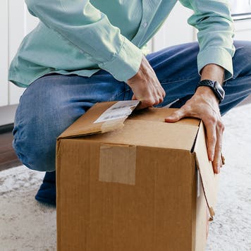 Man Opens Package After Delivery of Online Order