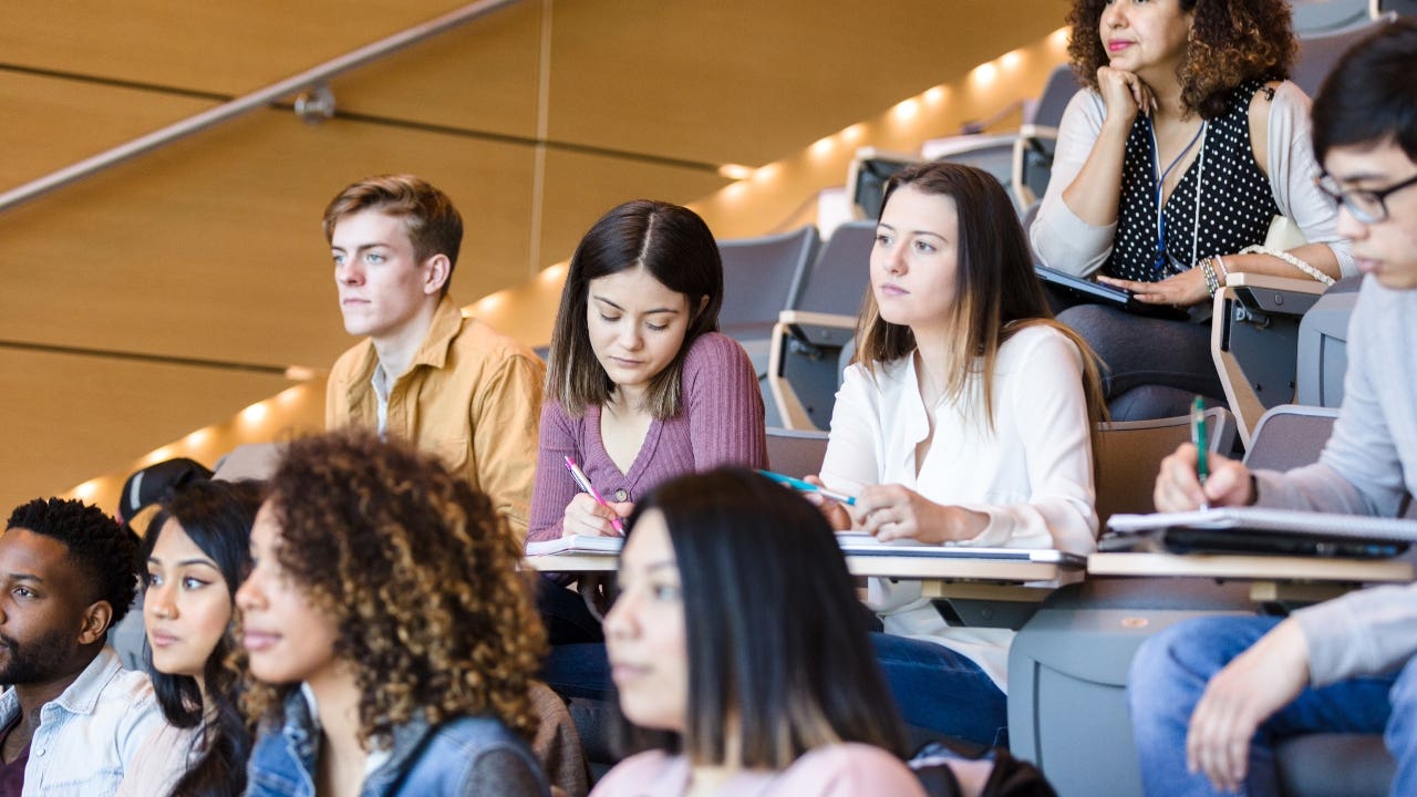 College students sit in a lecture hall