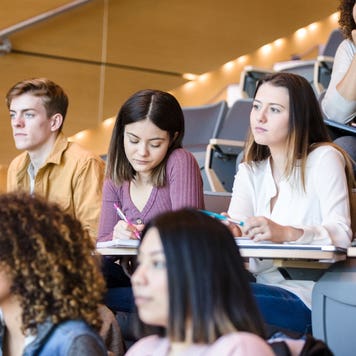 College students sit in a lecture hall