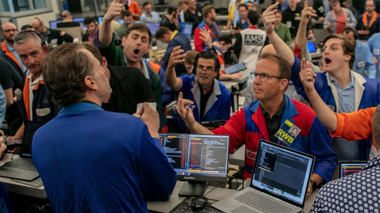 Traders on the exchange floor try to place orders