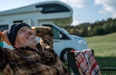 Man relaxing in front of his RV