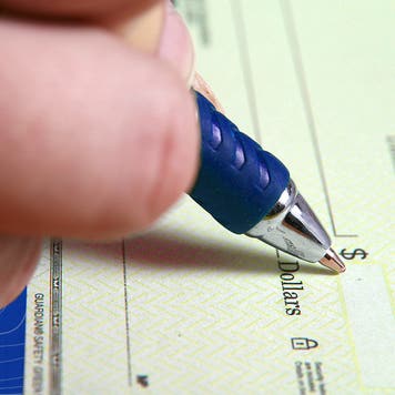 Filling in a blank check with a pen