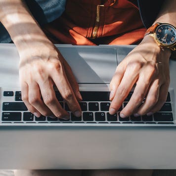 Image of person on laptop from above