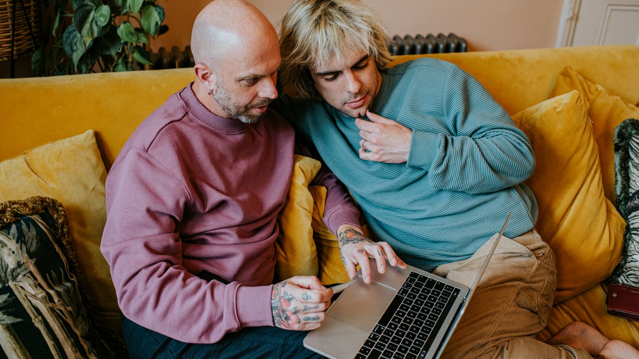 couple on couch looking at a computer