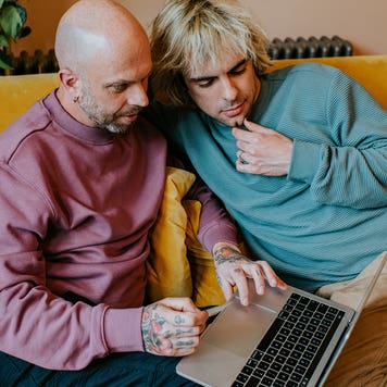 couple on couch looking at a computer