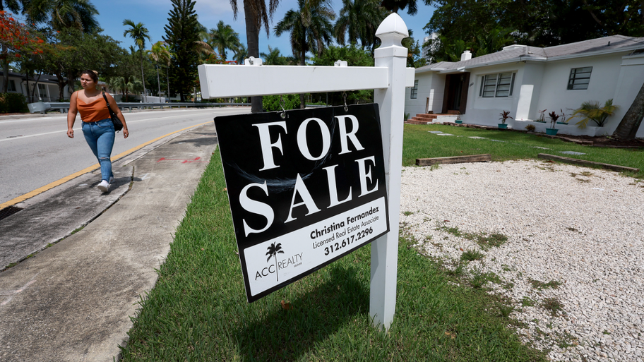A 'for sale' sign hangs in front of a home on June 21, 2022 in Miami, Florida