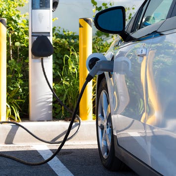 an electric vehicle charging at a charging station