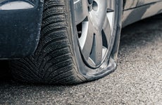 flat car tire close up, punctured wheel