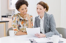 Agent reviewing paperwork with a client