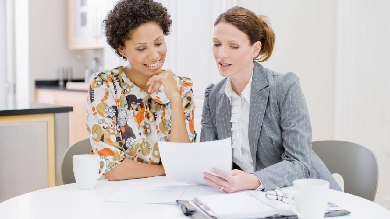 Agent reviewing paperwork with a client