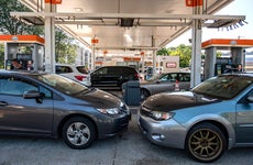 Cars sit at gas pumps at a Gulf gas station, which is selling regular gas at $4.09 a gallon, in Lynnfield, Massachusetts, on July 19, 2022