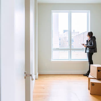 Teenager girls, sisters, looking around the new empty apartment