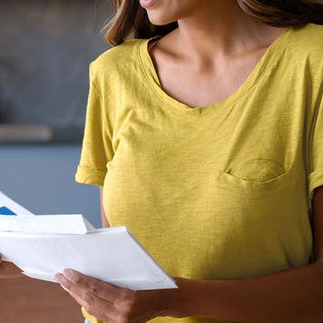 Woman at home checking the mail