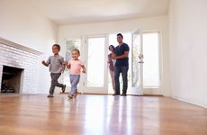 Kids running into a home with hardwood floors.