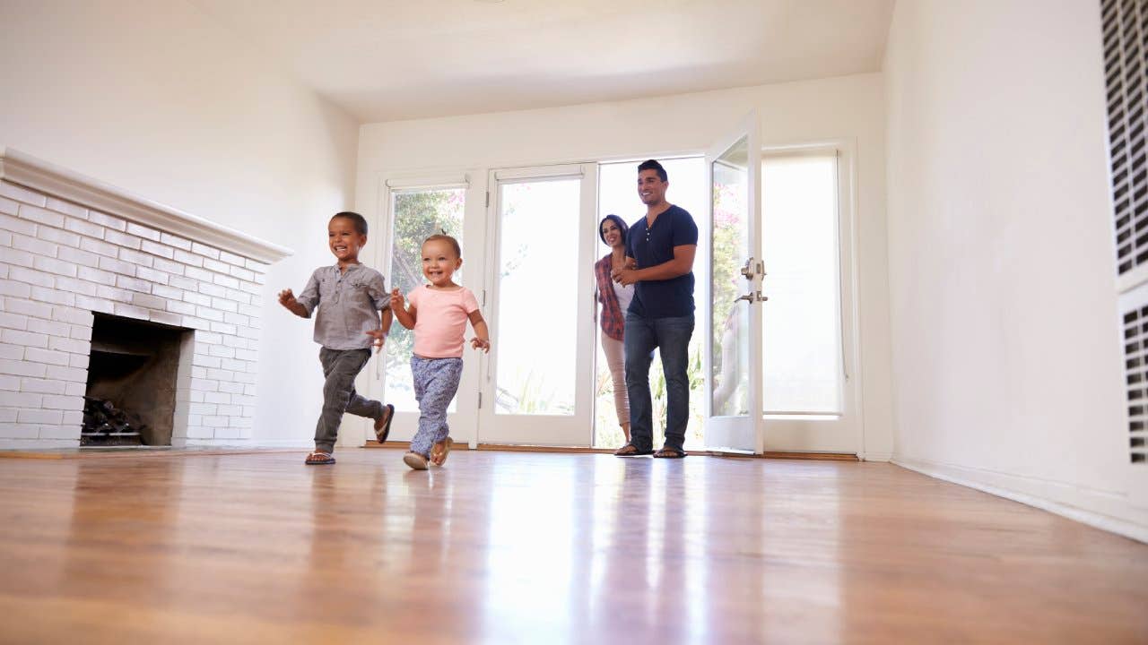 Kids running into a home with hardwood floors.