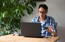Man using credit card for online purchase