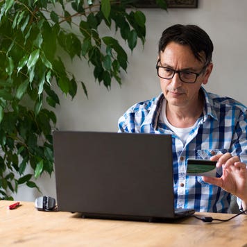 Man using credit card for online purchase