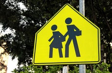 School children crossing traffic warning sign